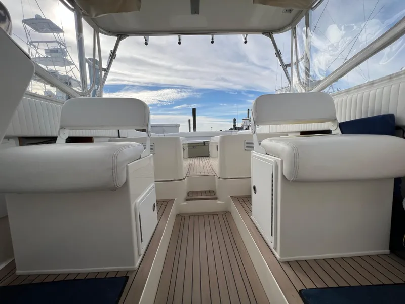 Slide: The Image of 1984 Bertram 26 Express boat interior with white seating and wooden flooring. - 12