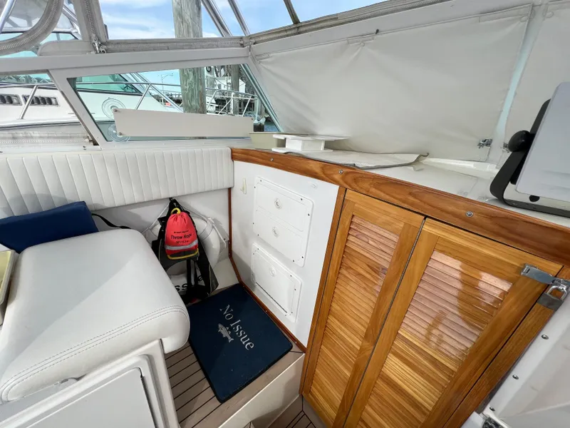 Slide: The Image of Interior of 1984 Bertram 26 Express boat with wood accents and seating. - 15