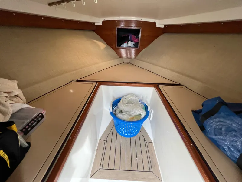 Slide: The Image of Interior of 1984 Bertram 26 Express boat with storage and blue basket. - 21