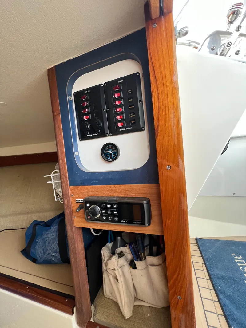 Slide: The Image of 1984 Bertram 26 Express interior with control panel and radio equipment. - 23