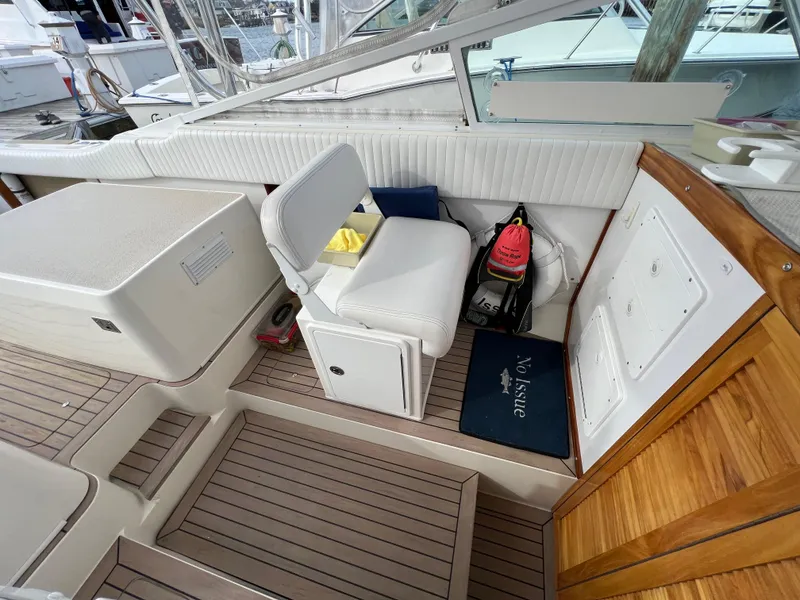 Slide: The Image of 1984 Bertram 26 Express boat interior with white seating and wooden accents. - 33