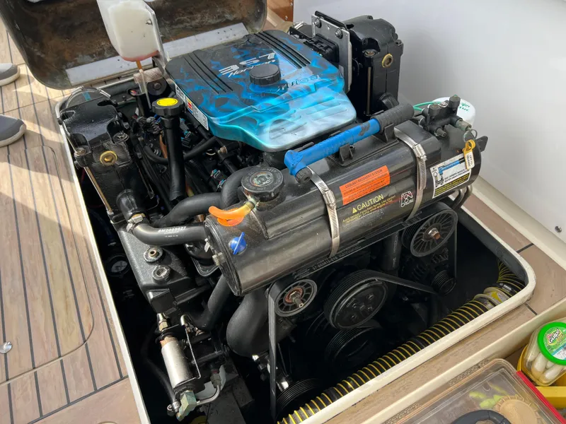 Slide: The Image of 1984 Bertram 26 Express engine compartment with detailed view of the motor components. - 38