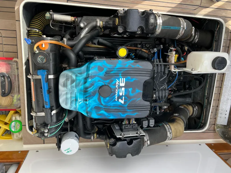 Slide: The Image of 1984 Bertram 26 Express engine with blue flame design, showcasing 5.7L V8 power. - 39