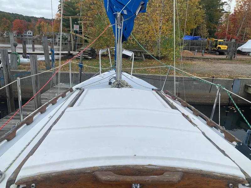 Slide: The Image of 1987 Catalina 25 sailboat docked in a marina during autumn. - 10