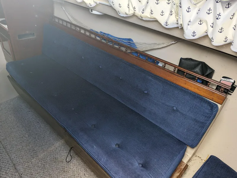 Slide: The Image of Interior seating of a 1987 Catalina 25 sailboat with blue cushions. - 18