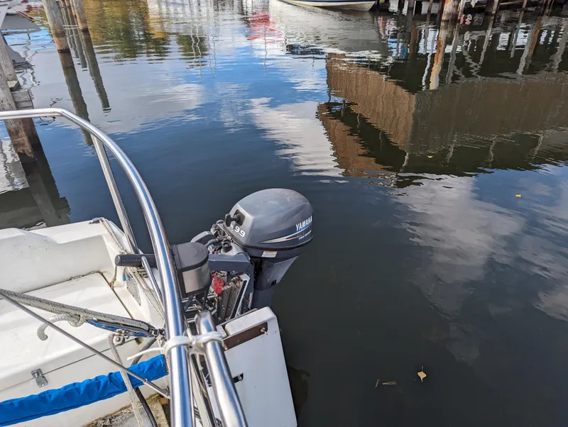 Slide: The Image of 1987 Catalina 25 sailboat with Yamaha outboard motor docked. - 7