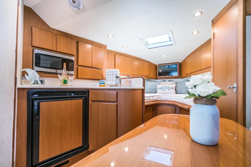 Slide: The Image of 2025 Henriques 35 Express yacht interior with modern kitchen and cozy sleeping area. - 18
