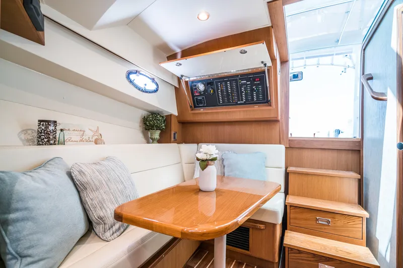 Slide: The Image of Henriques 35 Express 2025 interior with dining area, wooden table, and control panel. - 19