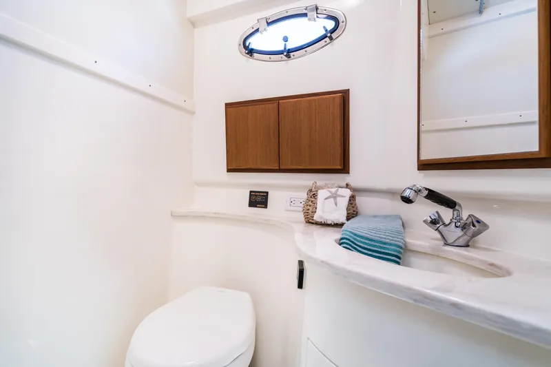 Slide: The Image of Henriques 35 Express 2025 yacht bathroom with modern fixtures and porthole window. - 20