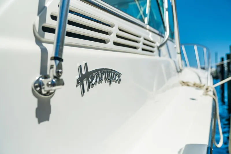 Slide: The Image of 2025 Henriques 35 Express boat side view with logo and railing. - 21