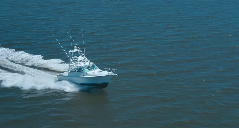 Slide: The Image of Henriques 35 Express 2025 model cruising on open water. - 4