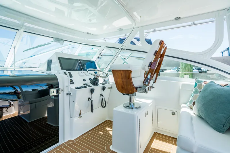 Slide: The Image of 2025 Henriques 35 Express yacht cockpit with modern controls and seating. - 8