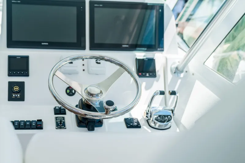 Slide: The Image of Helm of 2025 Henriques 35 Express boat with modern controls and displays. - 9