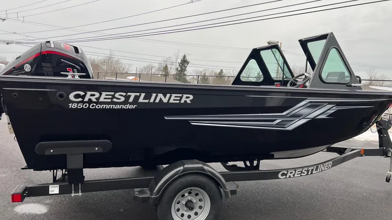 Slide: The Image of 2025 Crestliner 1850 Commander boat on trailer, black exterior, side view. - 1