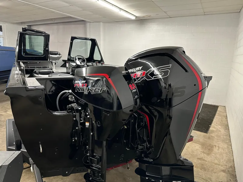 Slide: The Image of 2025 Crestliner 1850 Commander boat with dual Mercury outboard motors in a showroom. - 4