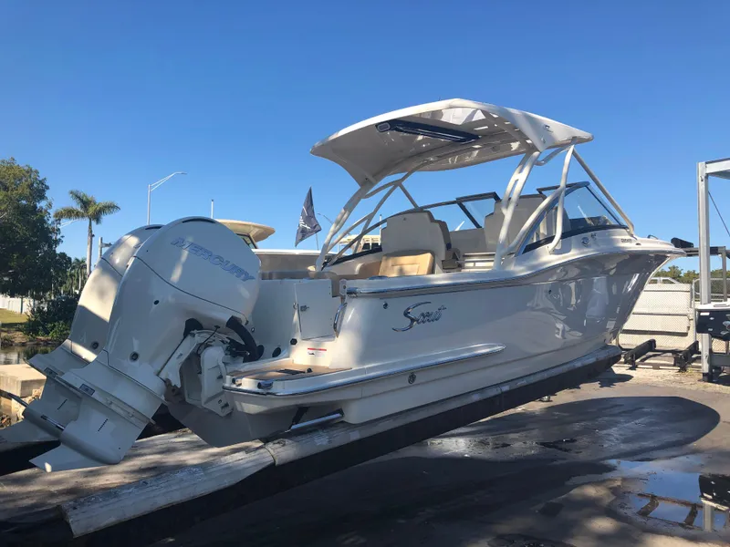 Slide: The Image of Scout 255 Dorado 2026 boat with Mercury engine on trailer. - 2