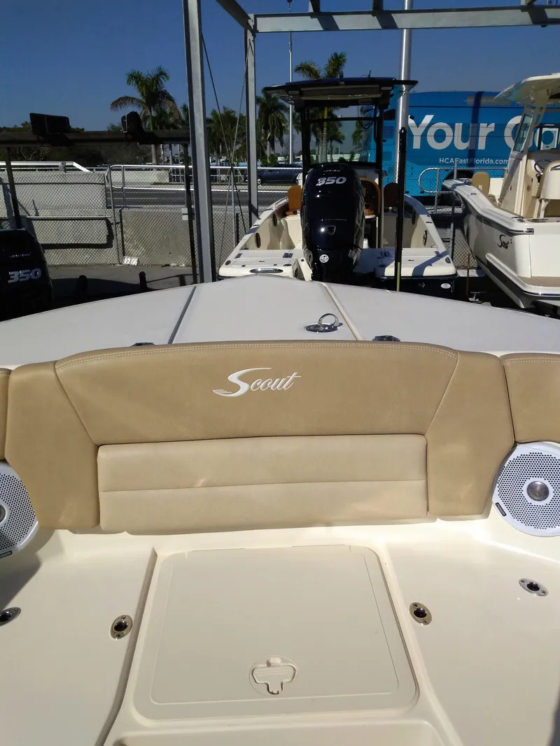 Slide: The Image of Scout 255 Dorado 2026 boat with beige seating and motor. - 26