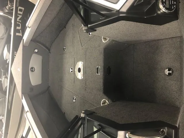 Slide: The Image of 2024 Lund 2075 Tyee boat interior with spacious deck and storage compartments. - 3