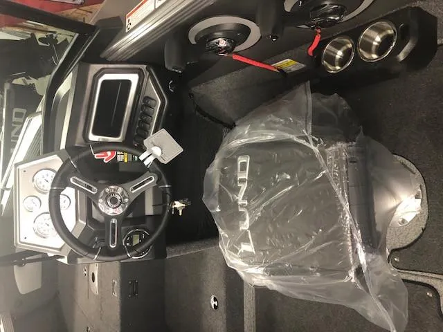 Slide: The Image of 2024 Lund 2075 Tyee boat interior with steering wheel and controls. - 5