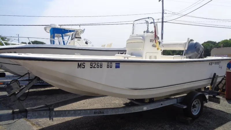 Slide: The Image of 2015 Key West 177 Skiff boat on trailer, parked outdoors. - 0