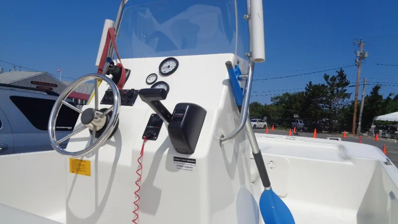 Slide: The Image of 2015 Key West 177 Skiff boat console with steering wheel and gauges. - 10