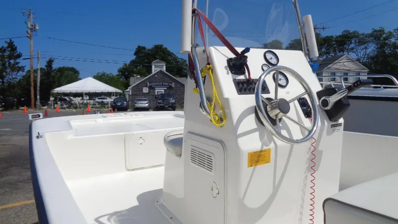 Slide: The Image of 2015 Key West 177 Skiff boat with steering console, parked outdoors. - 8