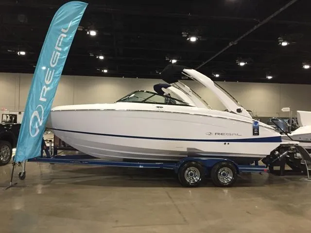 Slide: The Image of 2020 Regal LS4 boat on trailer in showroom. - 13