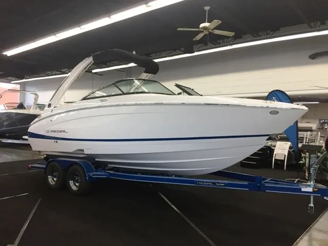 Slide: The Image of 2020 Regal LS4 boat on trailer in showroom. - 14