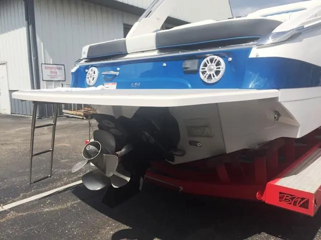 Slide: The Image of Rear view of a 2020 Regal LS4 boat on a trailer. - 15