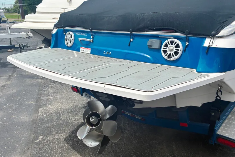 Slide: The Image of Rear view of a 2020 Regal LS4 boat with swim platform and propeller. - 2