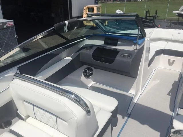 Slide: The Image of 2020 Regal LS4 boat interior with white seating and dashboard. - 20