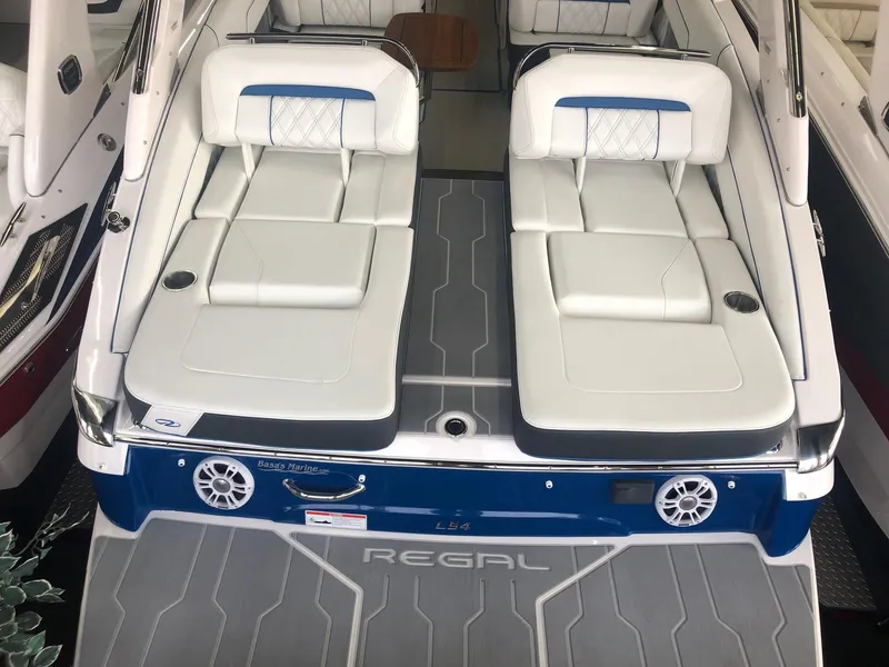 Slide: The Image of 2020 Regal LS4 boat with luxurious white seating and speakers. - 25