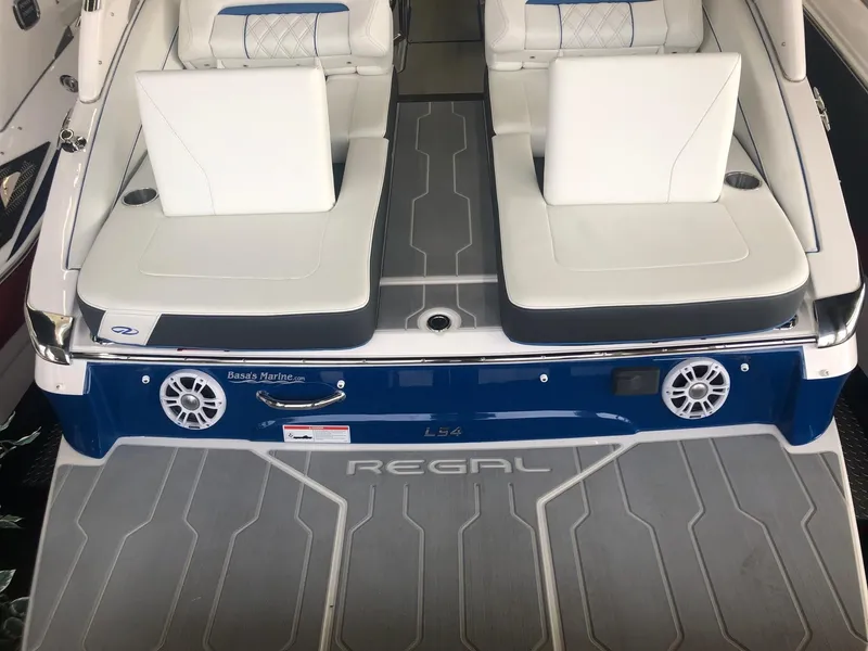 Slide: The Image of Rear view of a 2020 Regal LS4 boat with white seats. - 27