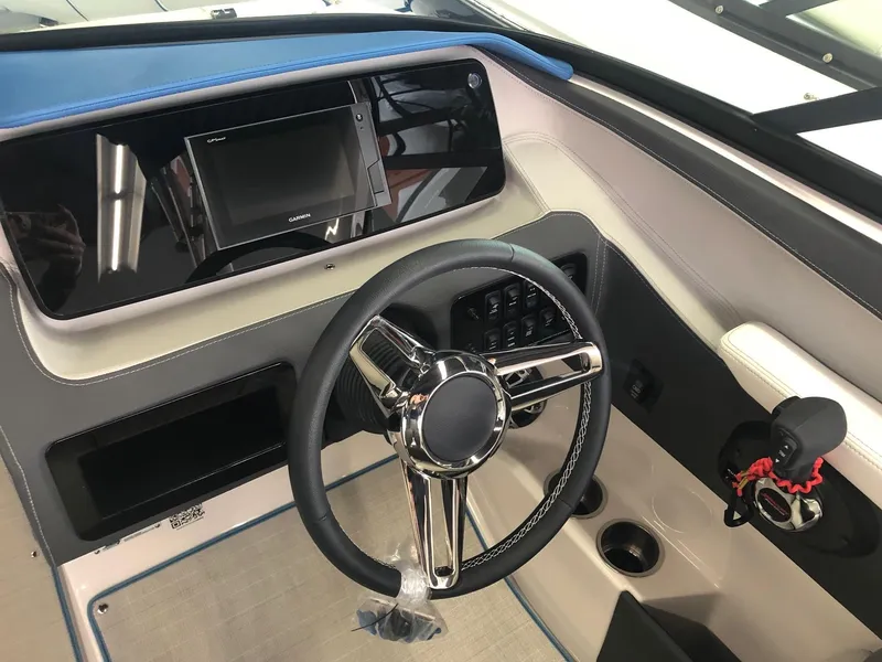 Slide: The Image of Interior of a 2020 Regal LS4 boat with steering wheel and dashboard. - 34
