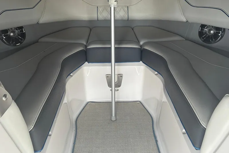 Slide: The Image of Interior of 2020 Regal LS4 boat with cushioned seating and speakers. - 7