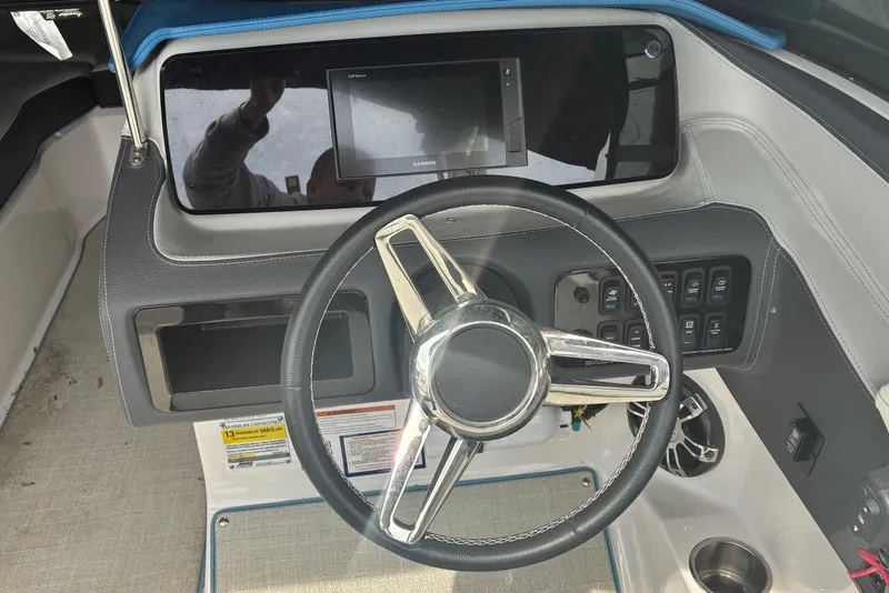 Slide: The Image of 2020 Regal LS4 boat dashboard with steering wheel and control panel. - 8