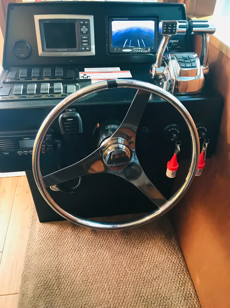 Slide: The Image of Steering wheel and control panel of 2014 Bravada Imagination Trip 11 boat. - 2