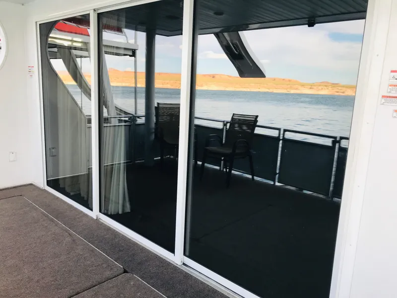 Slide: The Image of 2014 Bravada Imagination Trip 11 houseboat with glass doors overlooking serene lake view. - 23