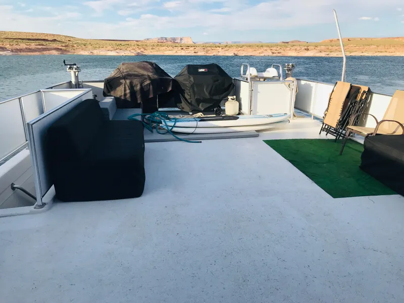 Slide: The Image of 2014 Bravada Imagination Trip 11 houseboat deck with seating, grills, and scenic lake view. - 25