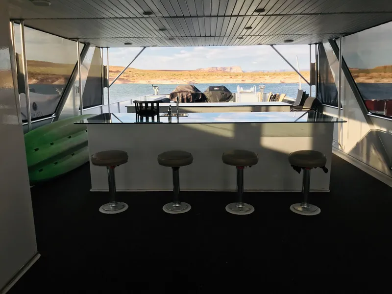 Slide: The Image of Interior of 2014 Bravada Imagination Trip 11 houseboat with bar stools and lake view. - 29