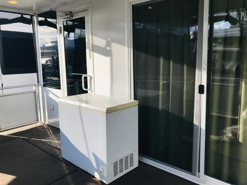 Slide: The Image of 2014 Bravada Imagination Trip 11 houseboat deck with sliding glass doors and storage unit. - 31