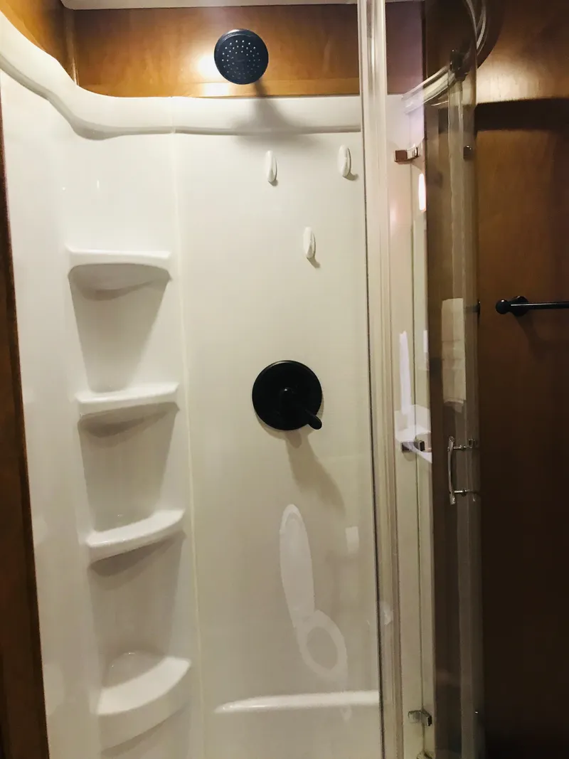 Slide: The Image of Shower interior in 2014 Bravada Imagination Trip 11, featuring glass door and built-in shelves. - 7
