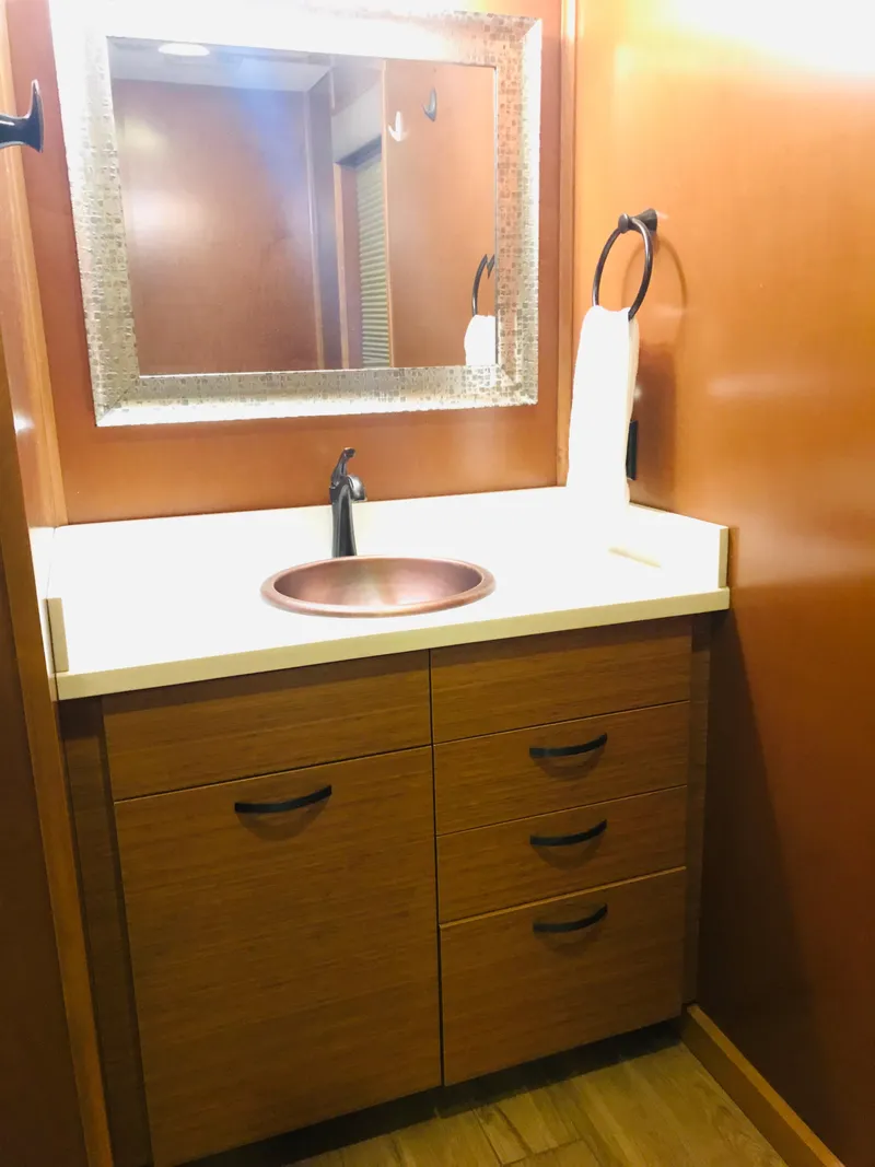 Slide: The Image of 2014 Bravada Imagination Trip 11 bathroom with wooden vanity and modern fixtures. - 8