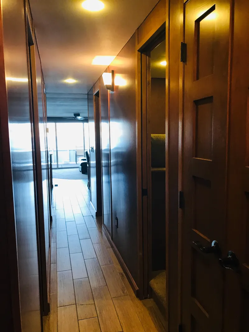 Slide: The Image of Narrow hallway in 2014 Bravada Imagination Trip 11 houseboat with wooden doors and flooring. - 9