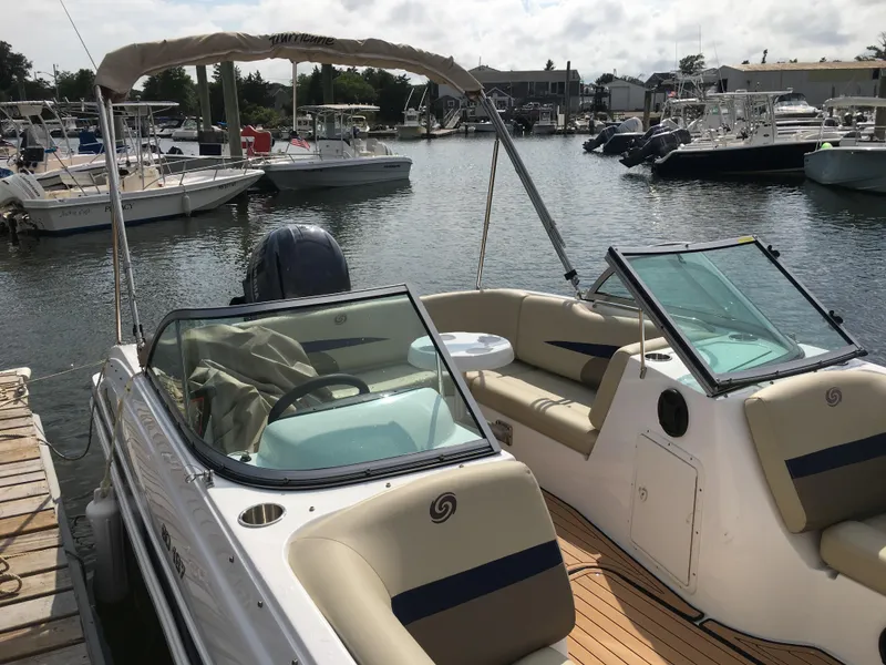 Slide: The Image of 2019 Hurricane SD 187 boat docked in a marina, featuring spacious seating and a sleek design. - 2