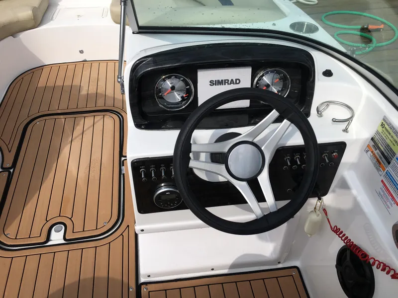 Slide: The Image of 2019 Hurricane SD 187 boat dashboard with Simrad display and wood-style flooring. - 4