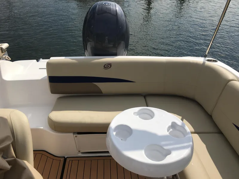 Slide: The Image of 2019 Hurricane SD 187 boat interior with seating and cup holder table on water. - 7