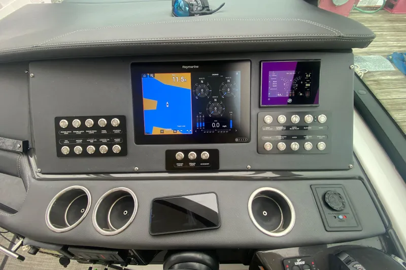 Slide: The Image of Dashboard of a 2020 Monterey 385 Super Express boat with navigation screens and controls. - 10