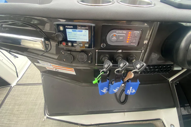 Slide: The Image of Control panel of 2020 Monterey 385 Super Express boat with keys and audio system. - 12