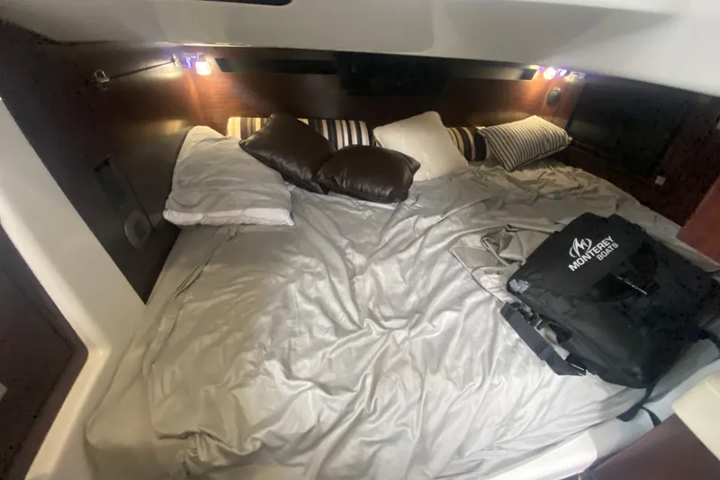 Slide: The Image of Cozy cabin interior of 2020 Monterey 385 Super Express with bed and pillows. - 20